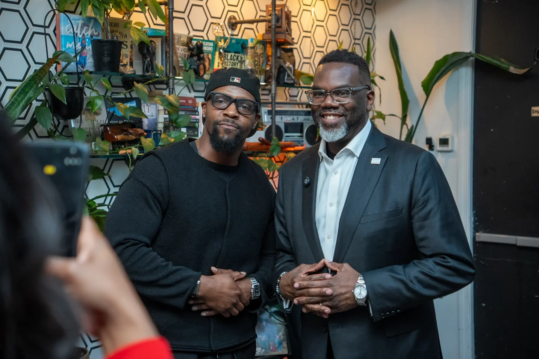 Two community leaders smiling together at a R.I.C.H. Foundation gathering.